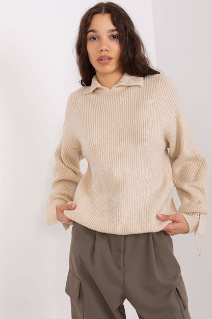 Cream-colored ribbed knit jumper with high collar, showcased on a model with long, dark hair against a white background.