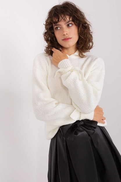 Cozy white knit jumper with wavy brunette hair, woman posing against white background