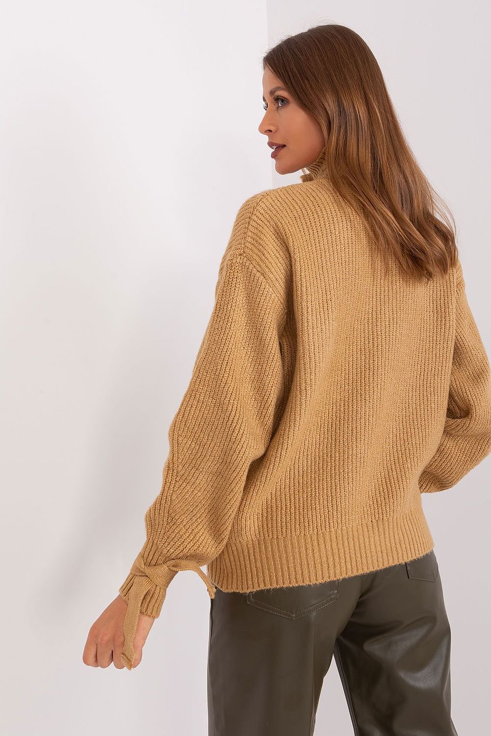 Beige ribbed knit jumper by Badu brand, worn by model with long brown hair against white background