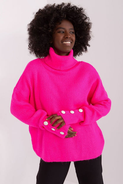 Model wearing bright pink turtleneck sweater with pearl details