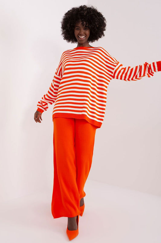 Striped orange and white knit top, loose-fitting orange pants, bold fashion statement