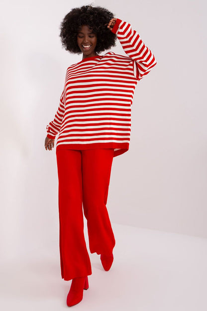 Red and white striped top with flared red pants, stylish and colorful fashion for women