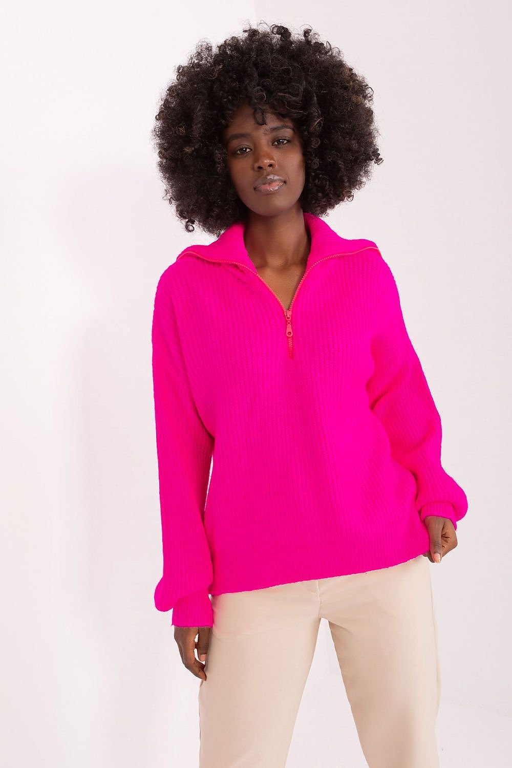 Cozy fuchsia turtleneck sweater with an alluring, voluminous curly hairstyle.