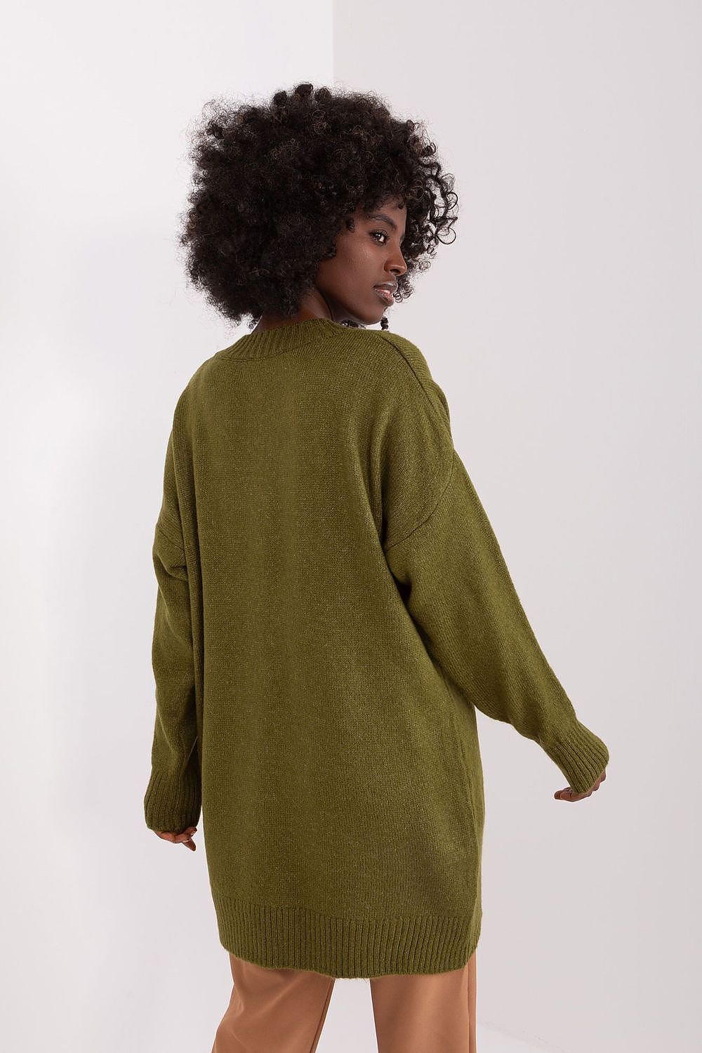 Cozy olive green knit jumper dress with a modern, curved silhouette and billowy sleeves. Warm, soft fabric and a relaxed, oversized fit for a comfortable, casual look.