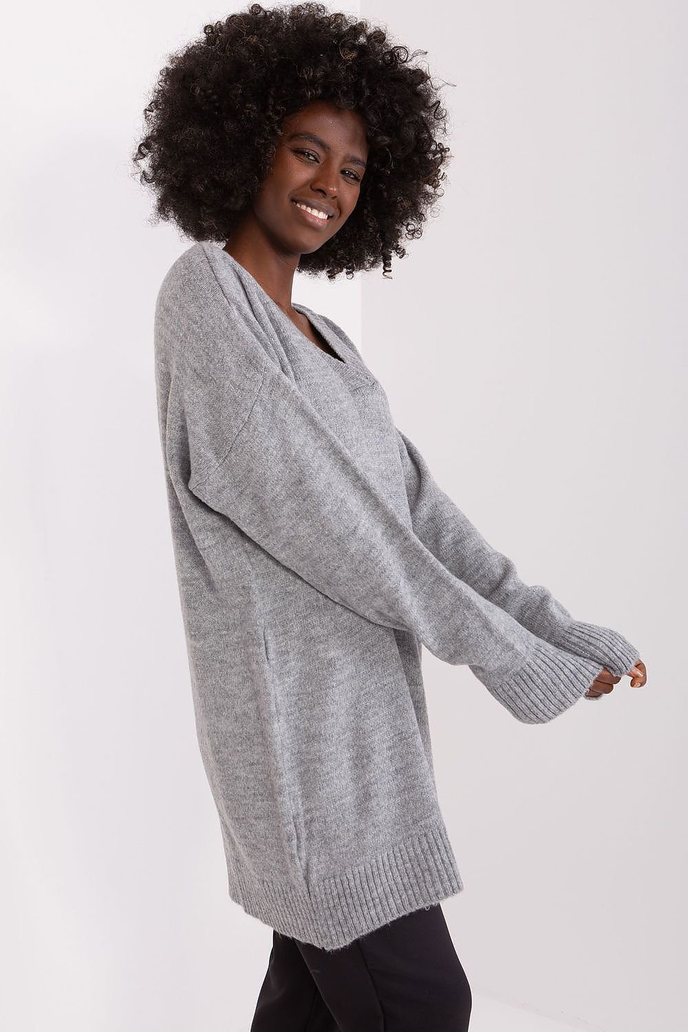 Cozy gray knit jumper with a woman's smiling face and curly dark hair in the image.