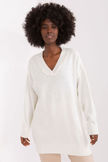 Stylish white sweater dress with a model's curly dark hair