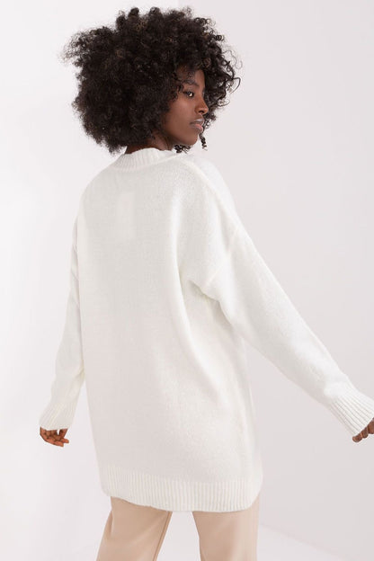 Cozy white knit jumper with model's natural curly hairstyle