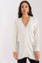 Cozy white cardigan with distressed pockets, modeled by a young woman with dark hair against a plain white background.