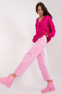 Vibrant pink cardigan and relaxed pink pants on female model