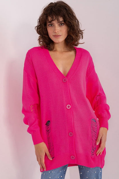 Vibrant fuchsia pink cardigan with a deep V-neck and button closure, showcased on a female model with curly brown hair against a plain background.