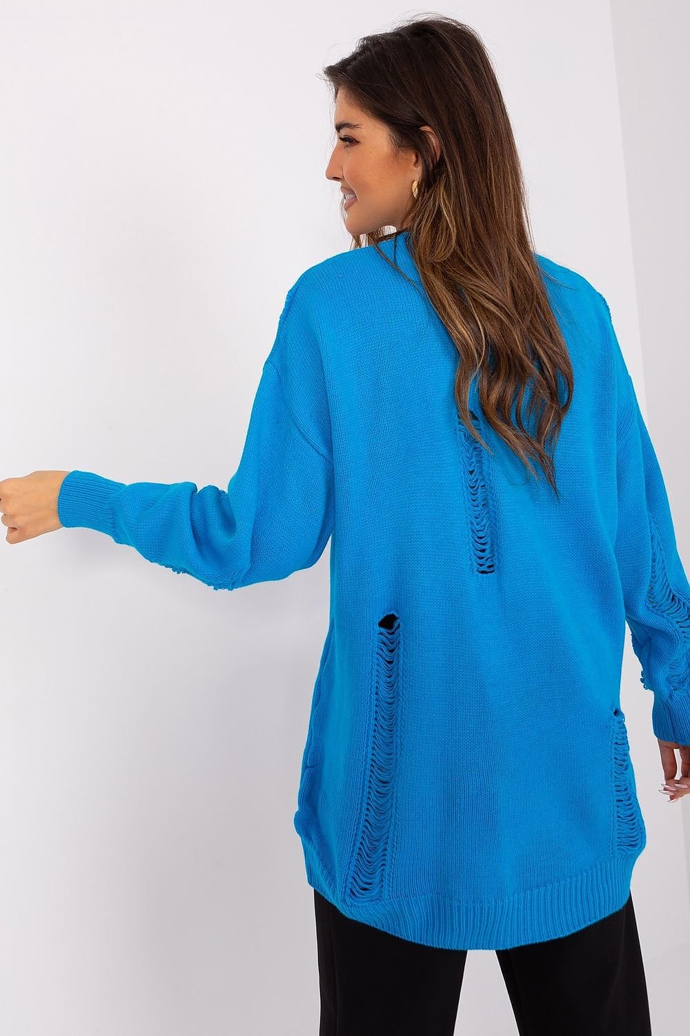 Bright blue oversized cardigan with ribbed detailing, modeled by a woman with long brown hair.