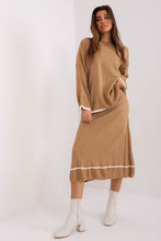 Load image into Gallery viewer, Elegant green ribbed midi dress with puff sleeves worn by a young woman with long brown hair, standing against a plain white background.