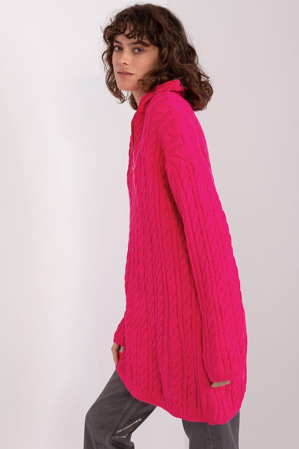 Elegant fuchsia pink cocoon-style cardigan by Badu, featuring a cozy cable knit design and flattering draped silhouette.