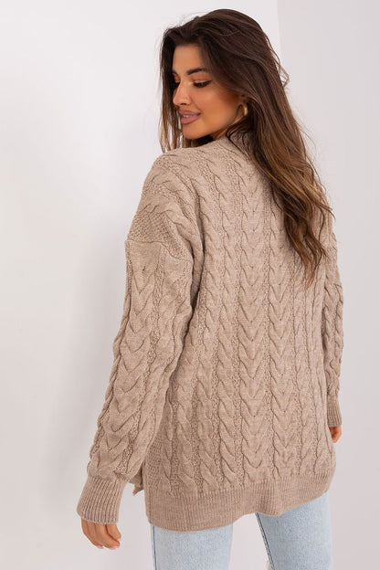 Elegant beige cable-knit sweater dress by Badu, worn by a smiling young woman with long brown hair