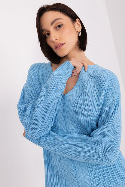 Elegant braided knit cardigan in a soothing sky blue color, showcased on a female model with dark hair against a plain white background.