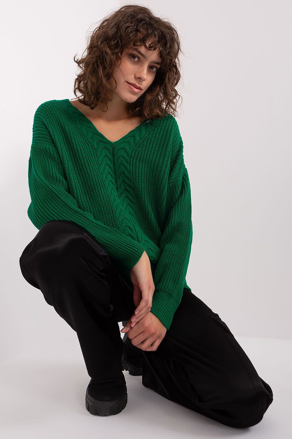 Cozy green knit pullover sweater by Badu, featuring a comfortable V-neck design and a relaxed fit for casual everyday style.