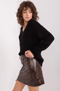 Cozy black ribbed crew neck sweater with stylish wavy hair framing an elegant woman's face.