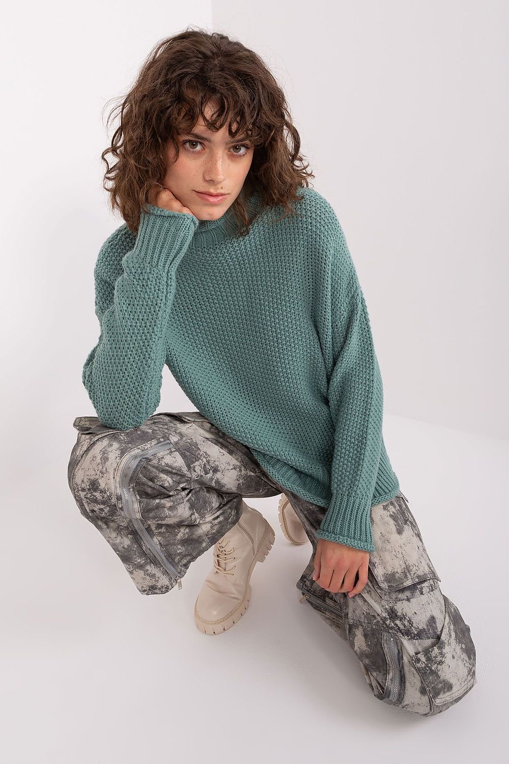 Soft, cozy turtleneck sweater in calming green, paired with patterned casual pants for a stylish, relaxed look.