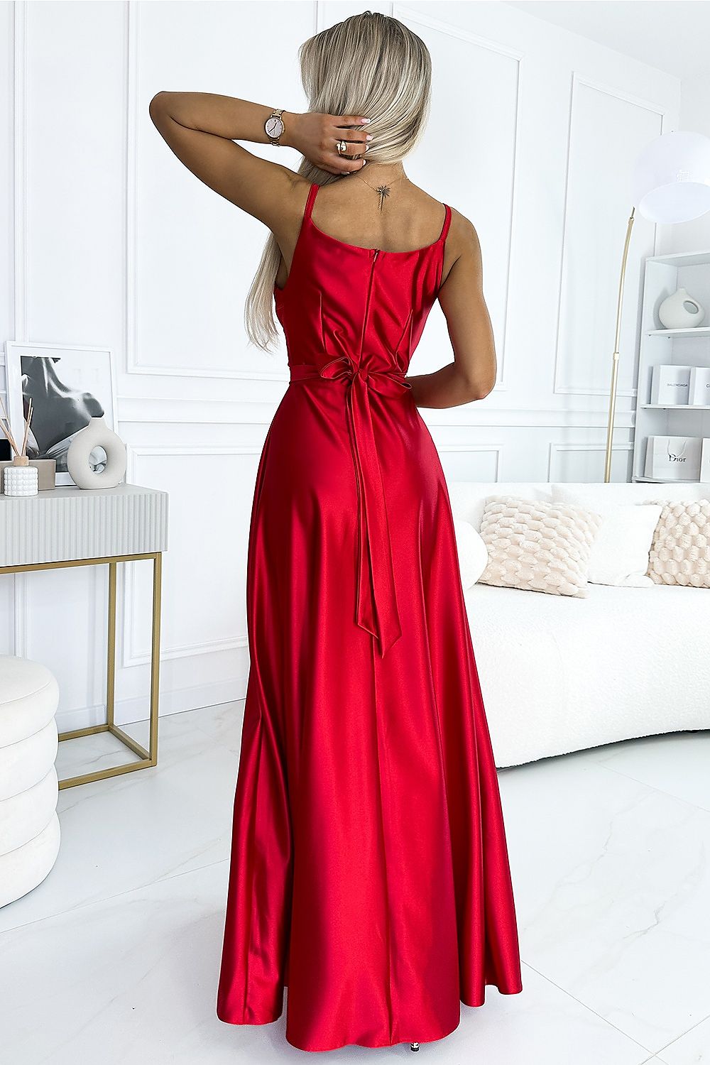 Elegant red maxi dress with spaghetti straps and a tie waist, showcasing a stylish and feminine look.