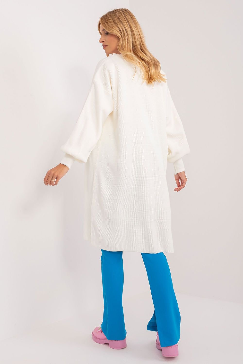 Elegant white longline robe coat with tie belt, worn by a woman with long blonde hair against a plain white background.