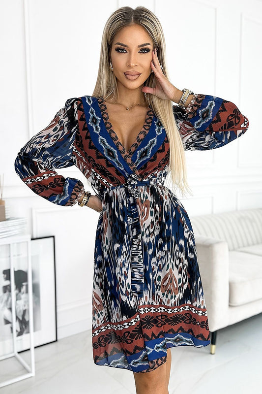 Flowing abstract printed pattern dress with deep neckline and voluminous sleeves, stylish modern elegant women's fashion attire.