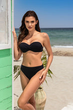 Load image into Gallery viewer, Stylish black two-piece swimsuit by Etna, showcased on a beautiful woman posing at the beach.