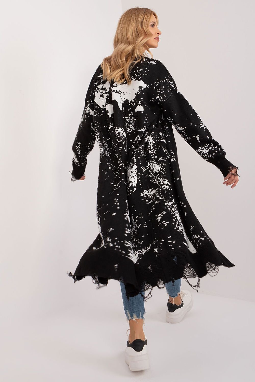 Elegant floral jacquard maxi cardigan in a striking black and white pattern, showcased on a fashionable model with blonde hair.