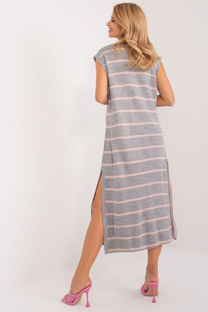 Elegant striped midi dress by Badu showcasing a woman's fashionable attire in a casual yet stylish setting.