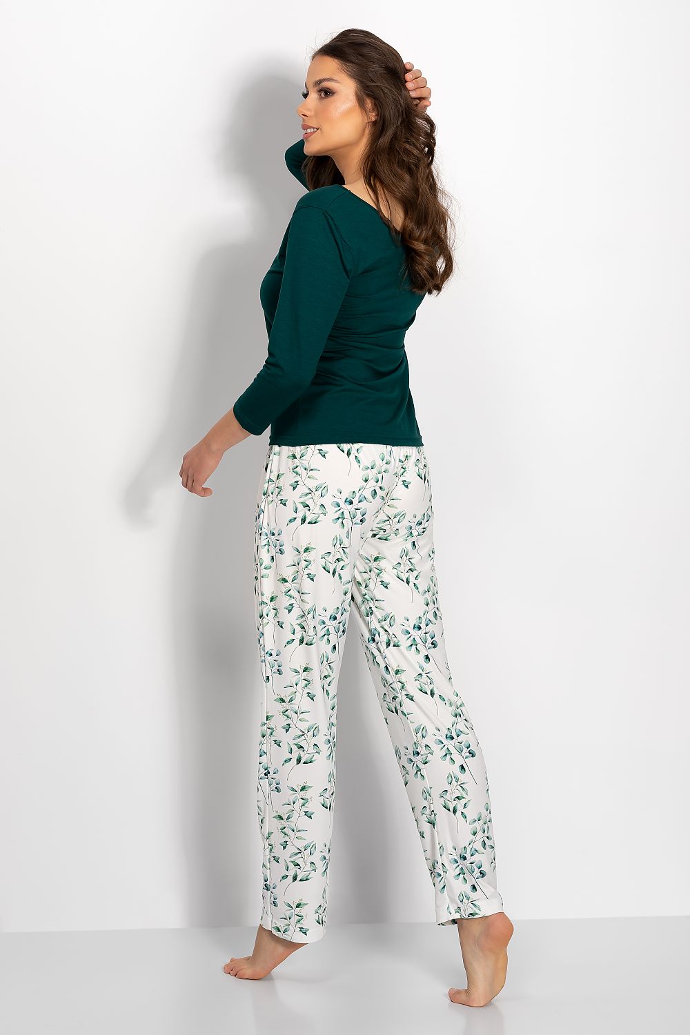 Elegant green top and floral print pajama bottoms displayed on model