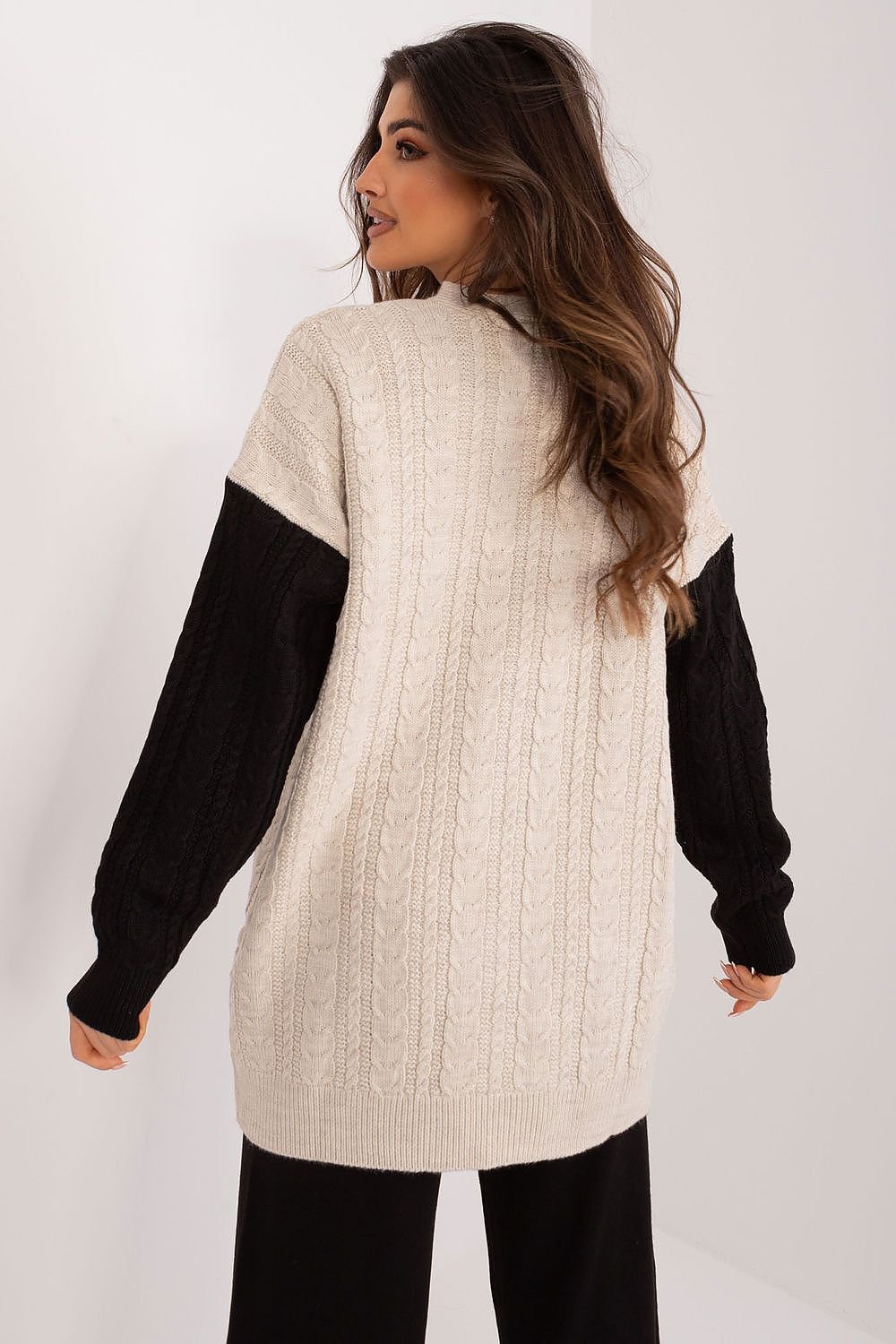 Chic faux fur trimmed cable knit sweater with contrasting sleeves, cozy winter fashion.