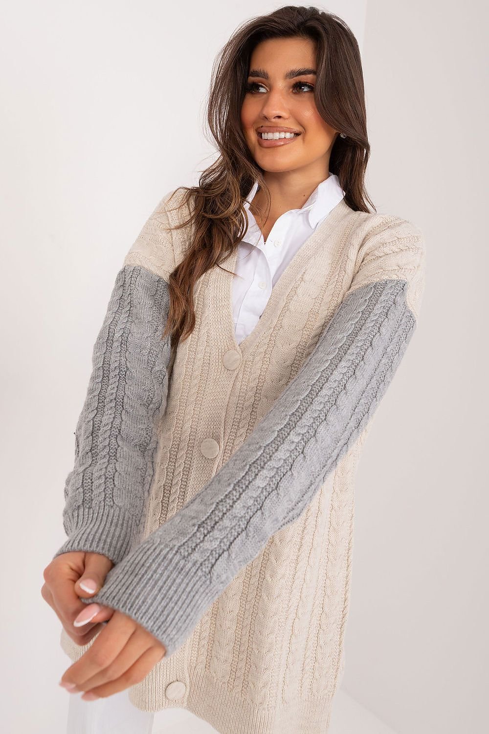 Chic faux fur trimmed cable knit sweater with a cozy, textured design in warm neutral tones.