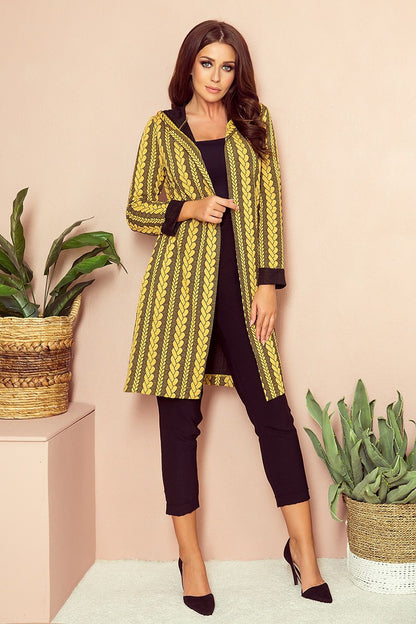 Stylish patterned yellow cardigan with a woman modeling it in a modern indoor setting.