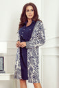 Stylish printed cardigan with long sleeves, worn over a navy blue dress by a young woman with long dark hair.