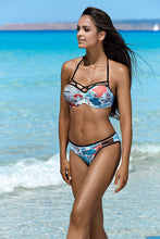 Load image into Gallery viewer, Tropical floral-printed two-piece swimsuit worn by stylish young woman on sunny beach