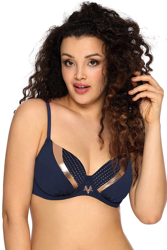 Curly-haired woman wearing a navy-blue bra with polka dots, showing off her stylish and feminine look.