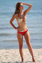 Vibrant floral bikini on slender female figure at beach