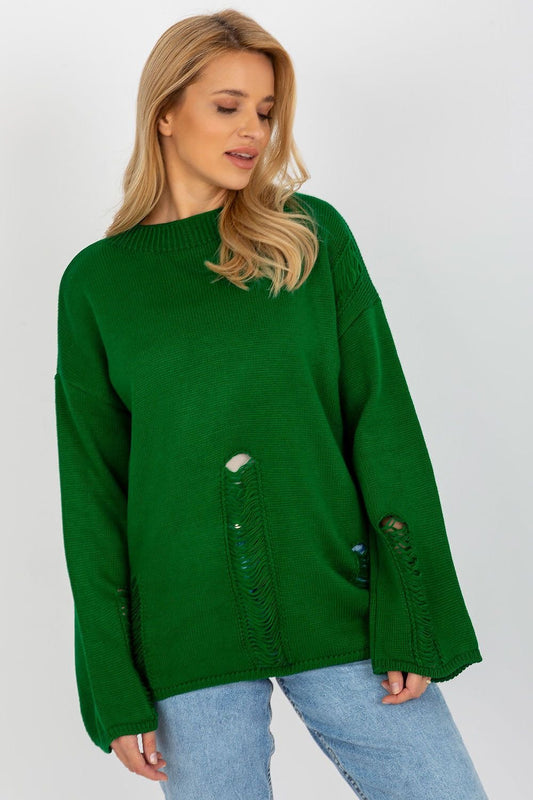 Green knit jumper with bell sleeves and distressed details on a smiling blonde woman against a white background