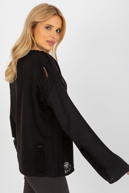 Cozy black woolen jumper with frilled details, modeled against a plain backdrop.