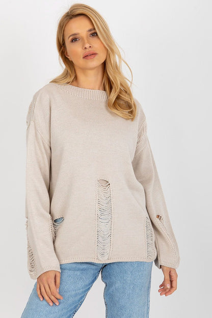 Cozy beige knitted jumper with distressed details, showcasing a relaxed and casual style.