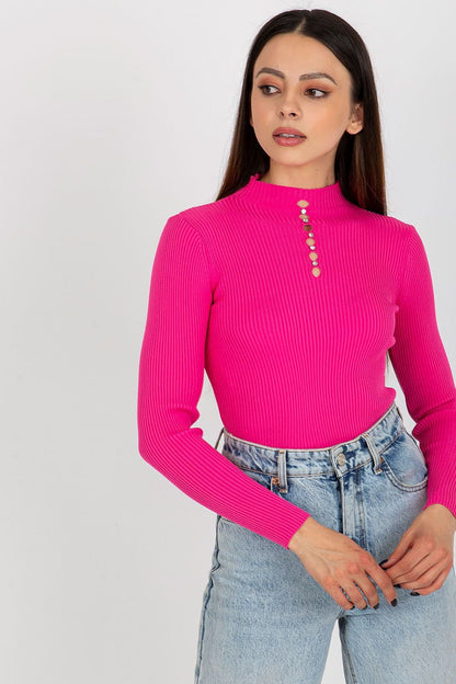 Vibrant retro-inspired ribbed knit top with button detail, worn by a young woman with long brown hair against a plain background.