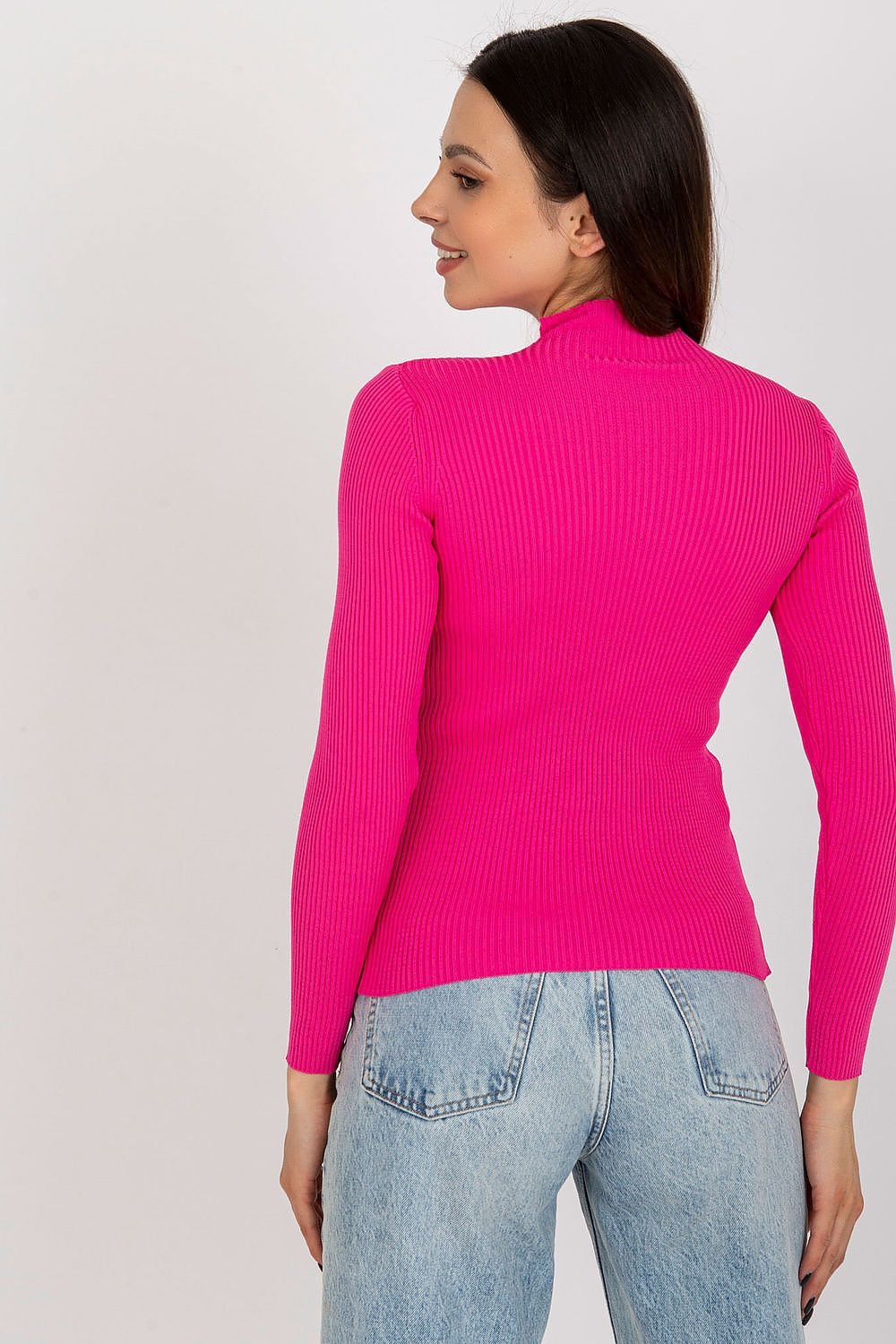 Vibrant pink ribbed knit top with mock neck, worn by a woman with brown hair against a plain background.