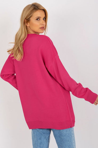 Cozy bright pink knit sweater with long sleeves and a relaxed, oversized fit.