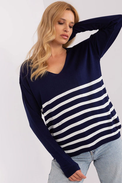 Striped navy blue and white jumper with a v-neck collar and long sleeves, modeled by a blonde woman