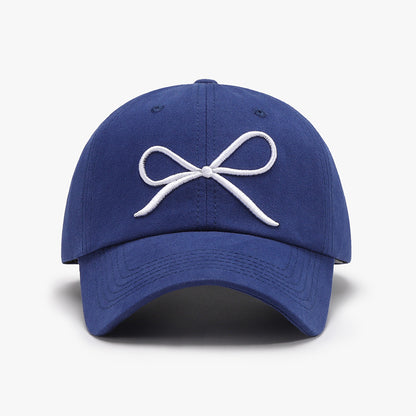 Navy blue baseball cap with a white bow embroidered logo