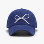 Navy blue baseball cap with a white bow embroidered logo