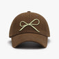 Elegant cotton baseball cap with a bow embroidered design in a neutral brown color, perfect for casual and stylish everyday wear.