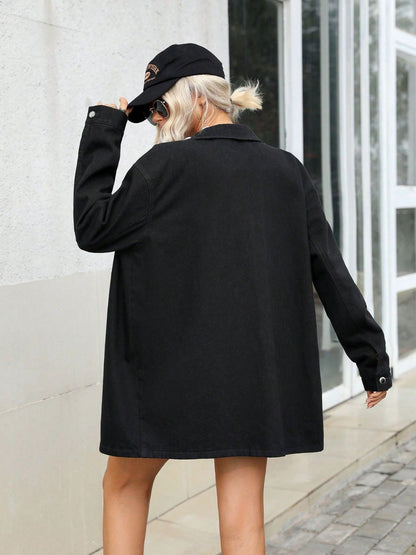 Stylish oversized black coat with fur-trimmed hood, worn by a young woman walking in an urban setting.