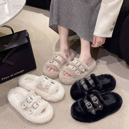 Faux Fur Furry Buckle Slippers - Cozy and stylish faux fur slippers with buckle details, showcased on a woman's feet in a home setting.