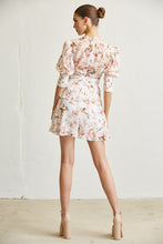 Load image into Gallery viewer, Elegant floral-print romper with puff sleeves and a flirty, ruffled hemline