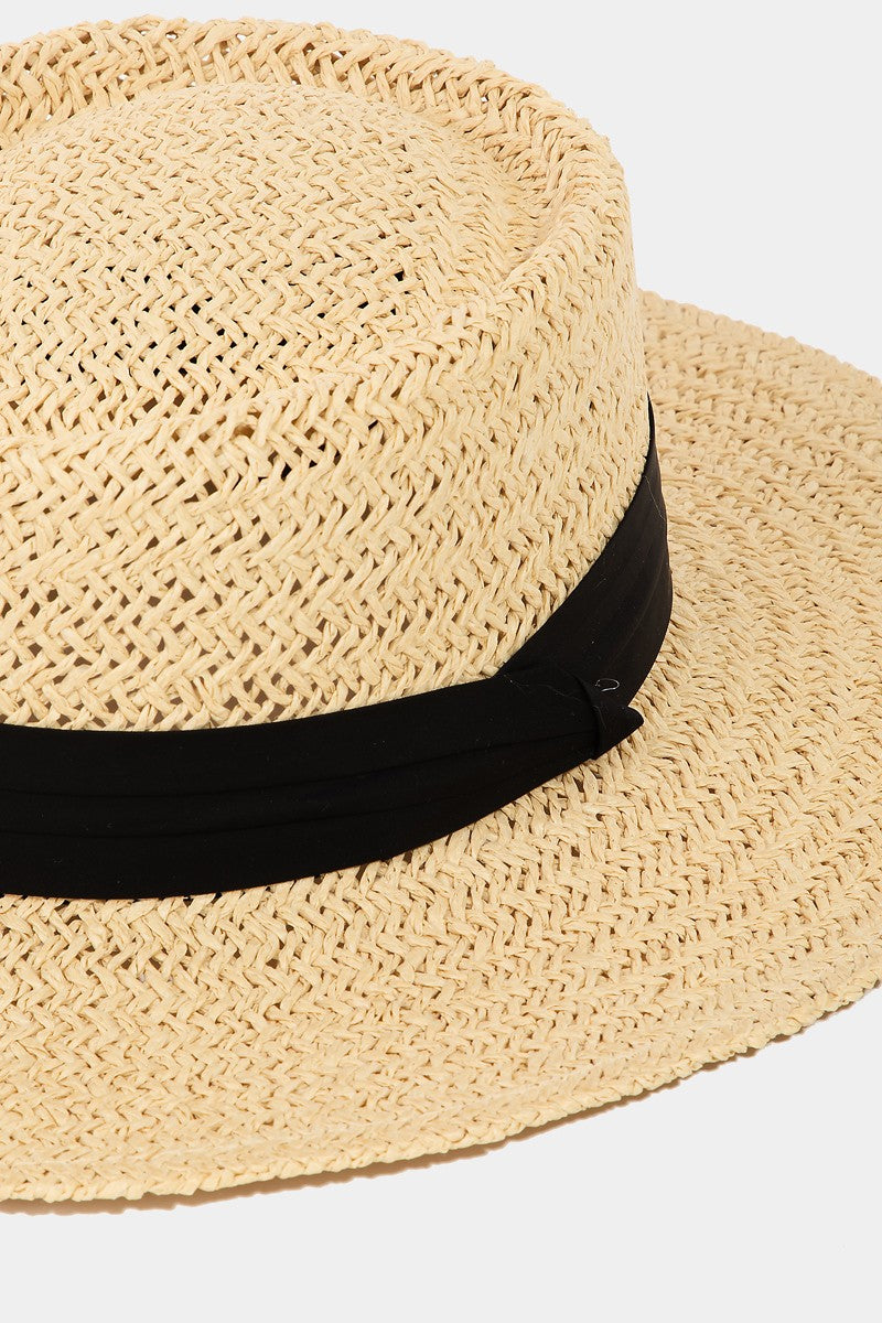 Stylish straw braided pork pie hat with a contrasting black band for a chic, casual look.